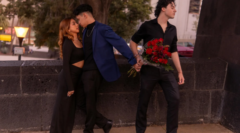 Man kissing a woman while secretly holding hands with another man behind his back, symbolising betrayal and emotional cheating. Why Do men Cheat